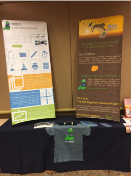 WRMD and The Wild Neighbors Database Project banners behind a table with a WRMD T-shirt.